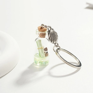 Detailed view of ocean driftwood bottle keychain with seashells and liquid filling