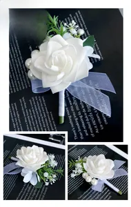 Detail of white artificial rose boutonniere with green leaves and elegant pearl accents