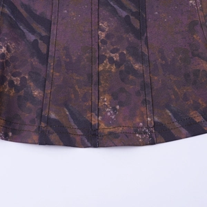 Detailed close-up of double-stitched hem on purple and brown leopard print fabric