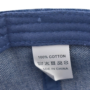Close-up of the 100% cotton label and internal stitching on the denim baseball cap