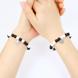 Couples beaded bracelets set featuring black and white beads with spider and web charms