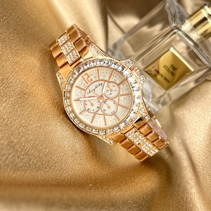 Rose gold luxury women's quartz watch with crystal bezel on elegant gold silk