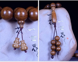 Macro detail of natural Wutai Mountain Liudaomu wood beads with gourd pendant