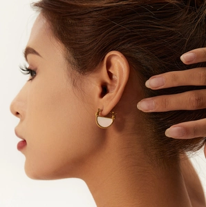 Retro 18K gold plated titanium earrings with white shell drop on female model
