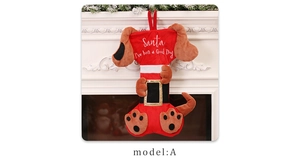 Detail of creative plush bone-shaped Christmas stocking with 'Santa I've been a Good Dog' text