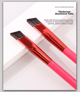 Macro detail of the wild eyebrow brush with red thickened aluminum tube and synthetic bristles