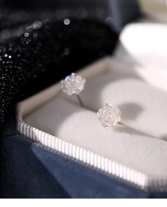 Macro shot of S925 silver rose studs featuring iridescent petals and delicate French style