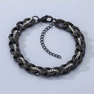 Detail of two-tone black and silver Cuban link bracelet with lobster clasp and chain