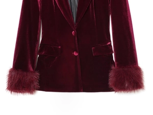 Detailed view of burgundy velvet blazer featuring plush faux fur cuffs and buttons