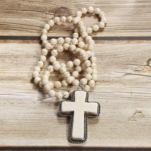 Detailed close-up of cream marble prayer beads and cross pendant with silver trim