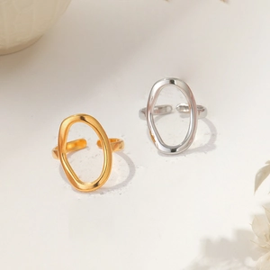 Detail view of gold and silver open rings with unique irregular oval hollow design