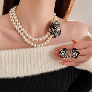 Vintage style double-layer pearl necklace and black floral earrings set with rhinestones