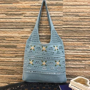 Sky blue knit tote bag with daisy floral embroidery and hollow mesh pattern