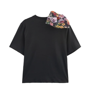 Women's black crewneck T-shirt featuring a 3D floral organza detail on the shoulder