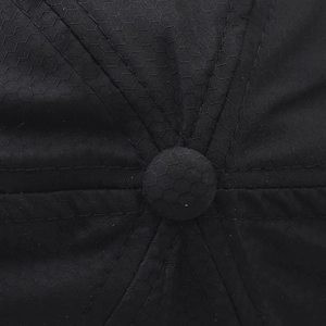 Macro detail of breathable honeycomb ripstop fabric and reinforced stitching on cap