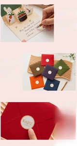 Detail of 3D rabbit pop-up card with colorful envelopes and gold seal stickers