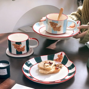 Hand-painted ceramic dog coffee cup set with bear relief and stripe pattern on wood table