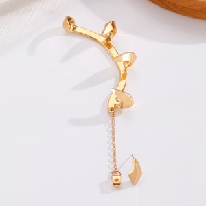 Detail of Gothic gold claw ear cuff featuring a punk tassel chain and metallic spikes