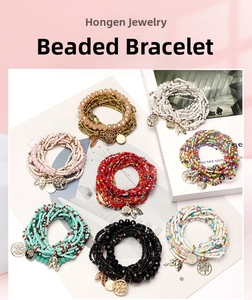 Macro shot of colorful Bohemian seed bead bracelets with life tree and leaf metal pendants