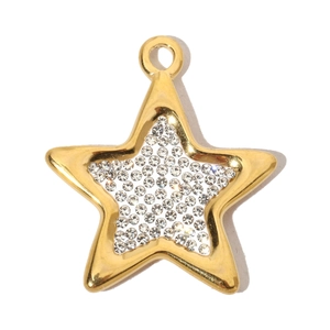 Macro shot of gold-plated star pendant with shimmering crystals on white background