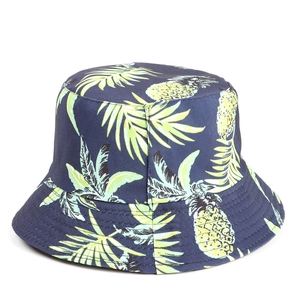 Detail of navy cotton bucket hat with yellow pineapple and green tropical palm leaf print