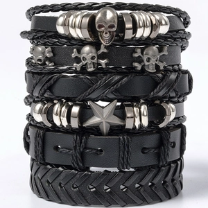 Detail view of 6-piece black leather bracelet set with silver skull and star charms