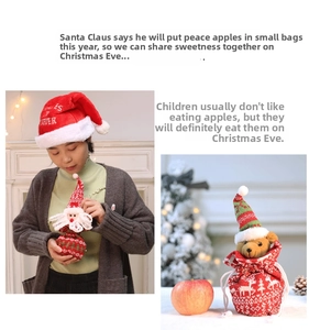 Close-up of Santa and bear knit Christmas gift bags with festive red and green textures