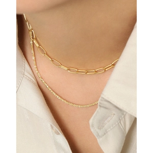 Gold paperclip and textured satellite link double layer necklace on a model
