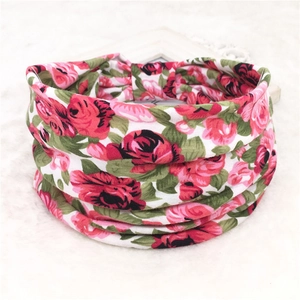 Detailed view of floral elastic sports headband with rose print on soft white faux fur