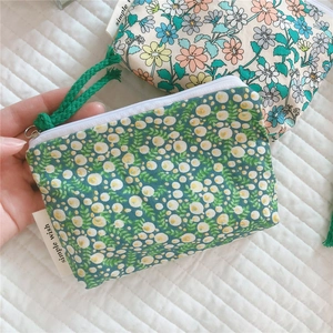 Detail of floral cotton mini coin purses with zipper closures and simple wish brand labels