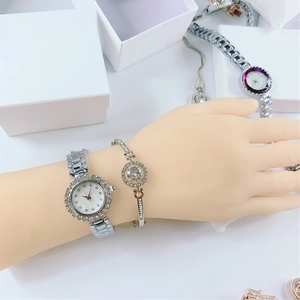 Detail of silver ladies quartz watch and matching crystal bracelet set on a wrist