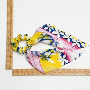 Tropical yellow floral scrunchie with long bow ribbon streamer and hibiscus pattern