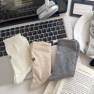 Detailed view of three cotton mid-calf socks with heart embroidery and lettuce trim