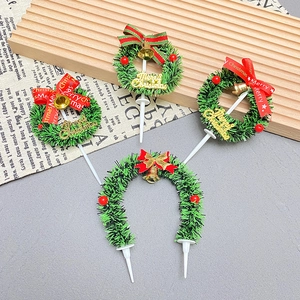 Mini Christmas cake wreath toppers with Merry Christmas signs, bows and bells