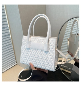 Détail de la texture en cuir synthétique matelassé blanc sur ce sac à main chic