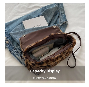 Detailed interior of plush leopard print handbag showing zipper compartment and capacity