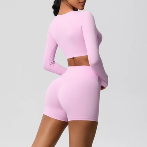 Rear view of pink tight-fit yoga set with long sleeve crop top and high waist shorts