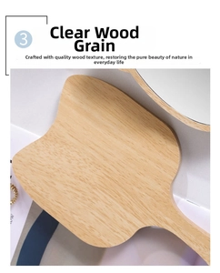 Detail shot of the natural wood grain texture on a professional handheld beauty mirror