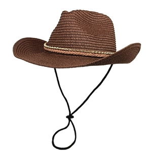 Detail of dark brown woven cowboy hat featuring golden bead trim and adjustable chin strap