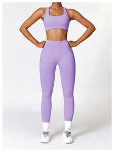 Detail of high-waist purple seamless yoga leggings and matching sports bra set