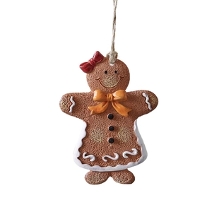Christmas gingerbread man ornament with red bow and white icing for festive tree decoration