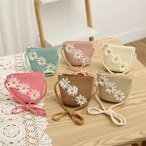 Detail of straw woven mini bags with white daisy floral decor in six vibrant colors