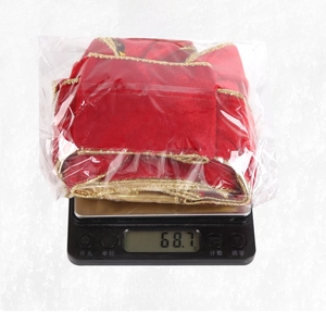 Detail view of double-layered red velvet Christmas bow weighing 68.7g in packaging