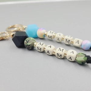 Close-up of MAMA silicone bead keychain with marble texture and golden metal clasp