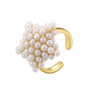 Macro view of French vintage gold open ring with clustered pearls in a star shape