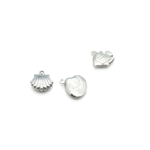 Hollow stainless steel sea animal charms with shell and fish shapes on white background