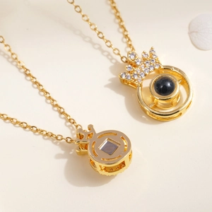 Golden crown projection necklace for women with zircon stones on a warm beige background