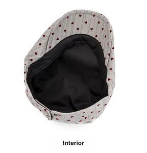 Detail view of the black cotton lining and sweatband inside the grey heart beret hat