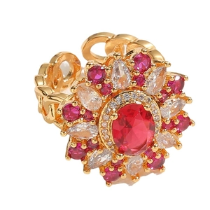 Luxury gold flower ring with red oval gemstone and white zircon petals on white background