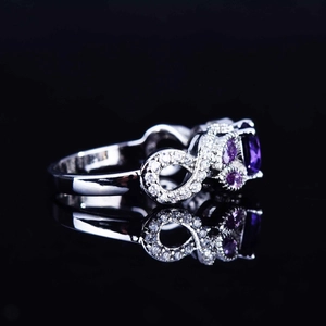 Silver infinity ring with oval purple amethyst and micro-paved cubic zirconia accents